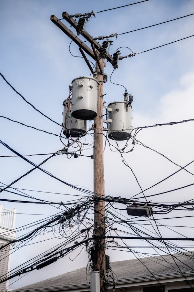 The Art of Drawing Readers In: Your attractive post title goes here A complex web of power lines and transformers on a utility pole in a city.