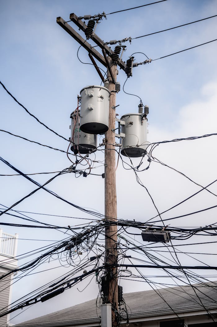 The Art of Drawing Readers In: Your attractive post title goes here A complex web of power lines and transformers on a utility pole in a city.